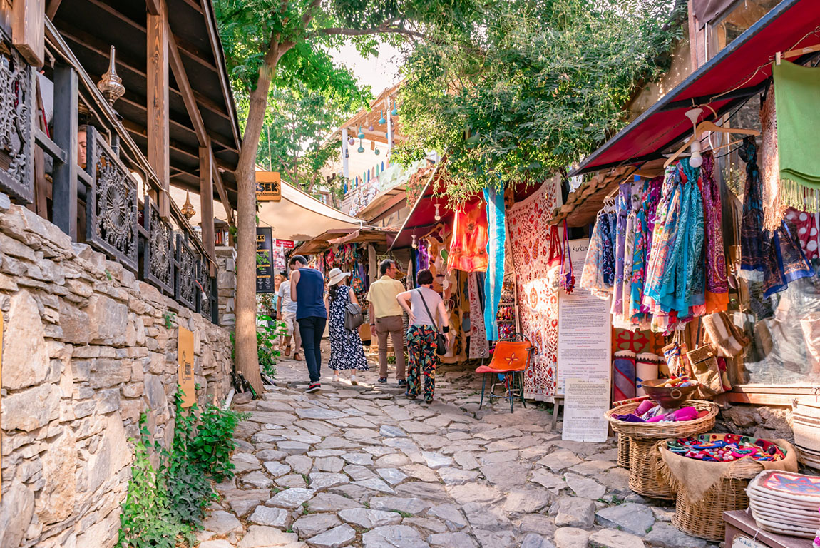 Clock tower and palm trees at night at Izmir