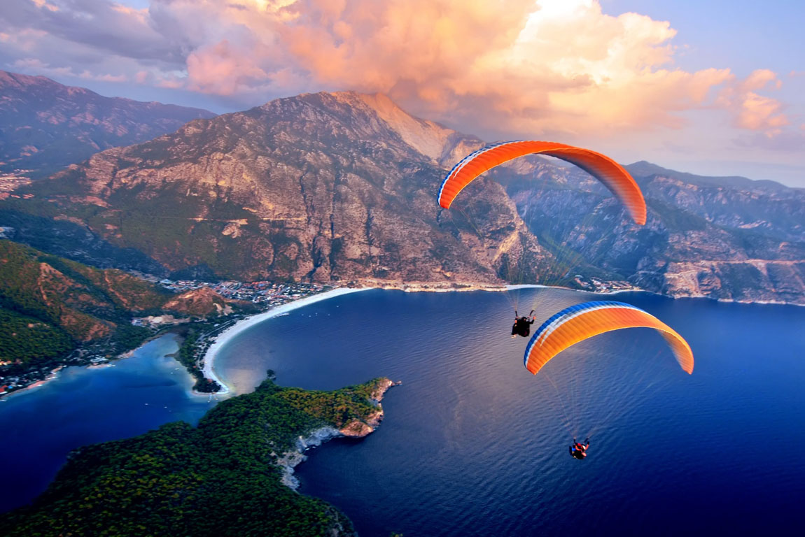Paragliding into the sunset over the ocean